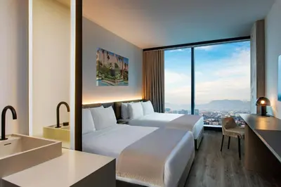 a hotel room with two beds and a large window at AC Hotel by Marriott Downtown Los Angeles in Los Angeles