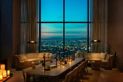 a living room with a table and a large window at AC Hotel by Marriott Downtown Los Angeles in Los Angeles