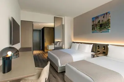 a hotel room with two beds and a desk at AC Hotel by Marriott Downtown Los Angeles in Los Angeles