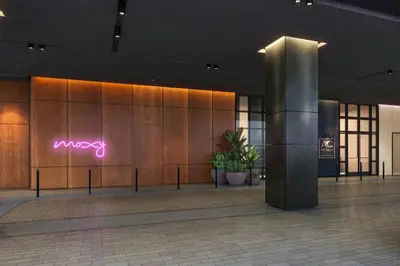 a lobby of a building with a neon sign on the wall at AC Hotel by Marriott Downtown Los Angeles in Los Angeles