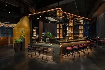 a restaurant with a bar with pink stools at Moxy Downtown Los Angeles in Los Angeles
