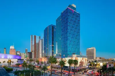 a city skyline with tall skyscrapers and palm trees at Moxy Downtown Los Angeles in Los Angeles