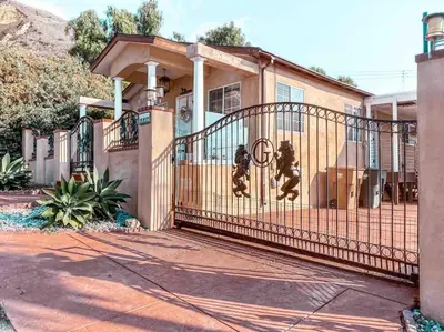 a house with an iron gate in front of it at Cozy beach home walking distance from ocean in Ventura
