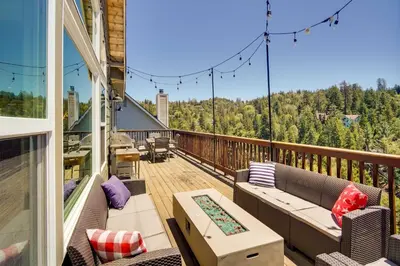 a balcony with couches and a view of the woods at Lake Arrowhead Getaway with Decks and Game Room! in Lake Arrowhead