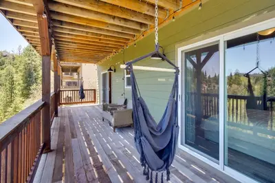a hammock on the porch of a house at Lake Arrowhead Getaway with Decks and Game Room! in Lake Arrowhead