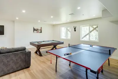 a living room with a ping pong table and a couch at Lake Arrowhead Getaway with Decks and Game Room! in Lake Arrowhead
