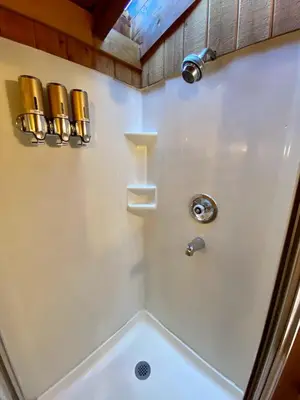 a white bathroom with a shower with a tub at Snow Bunny Cottage, Pets Welcomed! in Green Valley Lake