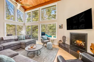 a living room with a couch and a fireplace at Timber Top Retreat in Lake Arrowhead