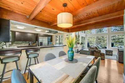 a kitchen and living room with a table and chairs at Timber Top Retreat in Lake Arrowhead