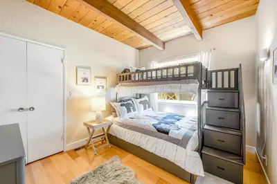 a bedroom with a bunk bed and a desk at Timber Top Retreat in Lake Arrowhead