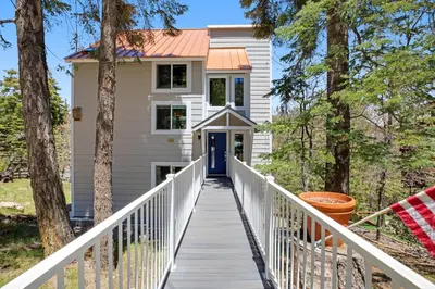 a house with a boardwalk leading to the front door at Timber Top Retreat in Lake Arrowhead