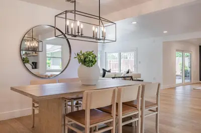 a dining room with a table and a mirror at #Marbella Lane - Cozy Modern Home with Relaxing Design & Pool in Fullerton