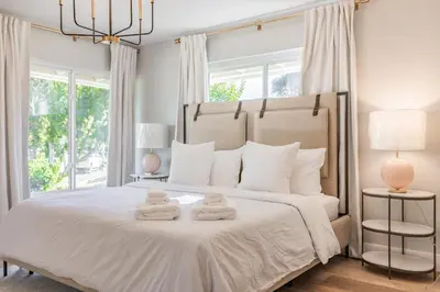 a bedroom with a large bed with two towels on it at #Marbella Lane - Cozy Modern Home with Relaxing Design & Pool in Fullerton