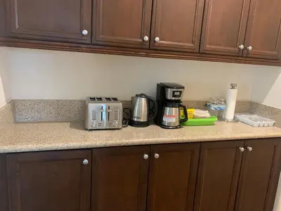 a kitchen counter with a toaster and coffee maker on it at HighEnd Rooms in Mansion in Riverside