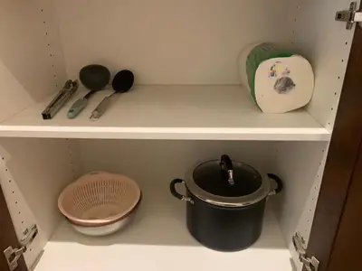 a shelf with a pot and other kitchen utensils at HighEnd Rooms in Mansion in Riverside