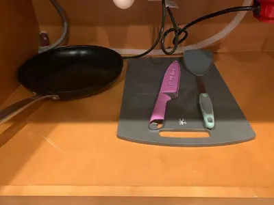 a cutting board with a knife and a spoon on it at HighEnd Rooms in Mansion in Riverside