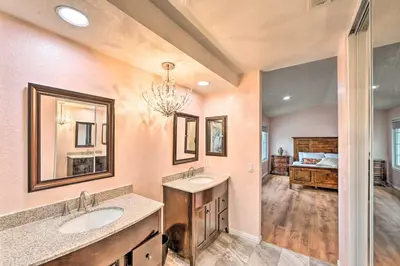 a bathroom with two sinks and a bedroom at Bright California Home with Patio Less Than 1 Mi to Hiking! in Corona