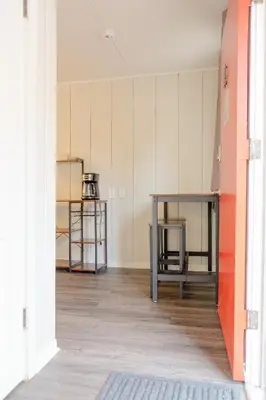 an empty room with a table and shelves at Sherwood Arms Motel in Running Springs