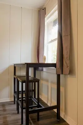a wooden table in a room with a window at Sherwood Arms Motel in Running Springs