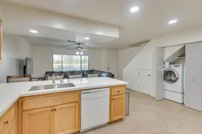 a kitchen with a sink and a dishwasher at Convenient Bakersfield Townhome with Patio! in Bakersfield