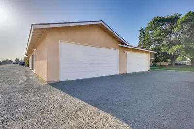 a garage with a white door on the side of a house at Convenient Bakersfield Townhome with Patio! in Bakersfield