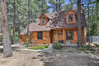a wooden cabin in the middle of a forest at Big Bear Lake Cabin about 4 Mi Snow Summit Ski Resort in Big Bear Lake