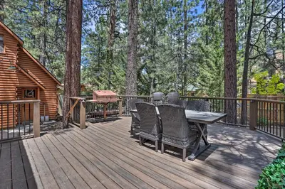 a wooden deck with a table and chairs on it at Big Bear Lake Cabin about 4 Mi Snow Summit Ski Resort in Big Bear Lake
