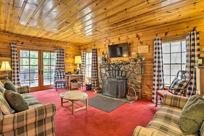a living room with a fireplace in a log cabin at Big Bear Lake Cabin about 4 Mi Snow Summit Ski Resort in Big Bear Lake