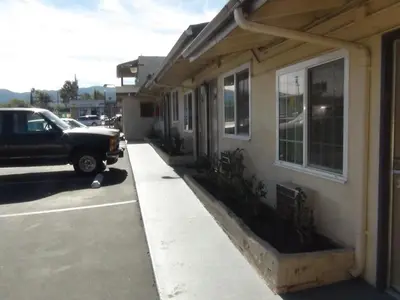 a truck parked in a parking lot next to a building at Desert Inn Motel in Corona