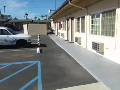 a car parked in a parking lot next to a building at Desert Inn Motel in Corona