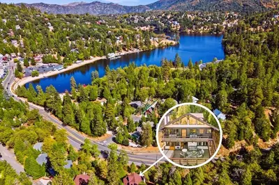 an aerial view of a house next to a lake at The Lake Chalet in Crestline