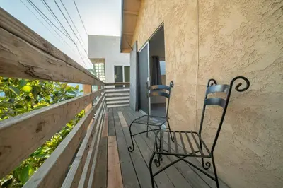 two chairs sitting on the porch of a house at Ocean View / Pool Table / Surfboards / Beach Bikes in Oxnard