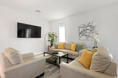 a living room with two couches and a tv at Adorable 3 bedroom with Jacuzzi & more in Los Angeles
