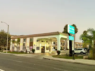 a hotel with a gas station on the side of the street at Casa Blanca Hotel - Cypress, Buena Park in Cypress