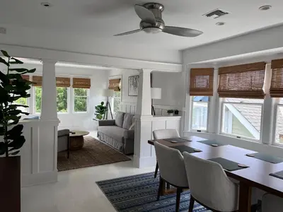 a dining room and living room with a table and chairs at The Craftsman House in Venice Beach in Los Angeles