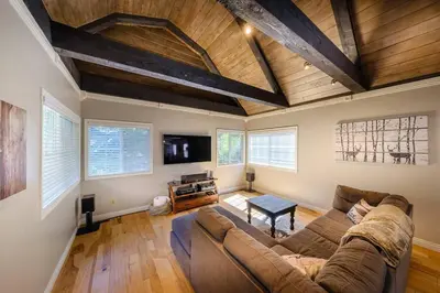 a living room with a couch and a tv at TheDragon's Den Mega Cabin Sleeps 12 in Lake Arrowhead