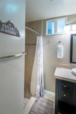 a bathroom with a shower and a sink at TheDragon's Den Mega Cabin Sleeps 12 in Lake Arrowhead