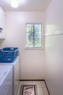 a white kitchen with a window and a dishwasher at TheDragon's Den Mega Cabin Sleeps 12 in Lake Arrowhead
