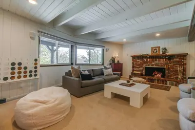 a living room with a couch and a fireplace at Roots Mountain House Modern A-Frame in Lake Arrowhead