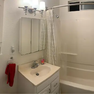 a bathroom with a sink and a mirror and a shower at Nearby Beach House in El Segundo