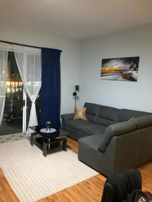 a living room with a couch and a table at 2 Bed Ocean View Balconys Corner Unit LB Convention Center in Long Beach