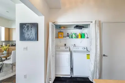a laundry room with a washer and dryer at 2 Bed Ocean View Balconys Corner Unit LB Convention Center in Long Beach
