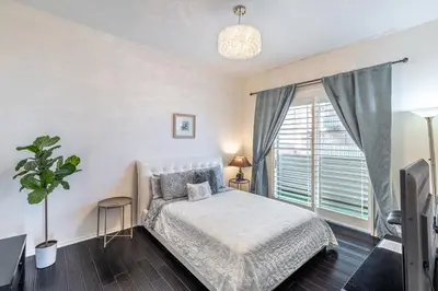 a bedroom with a bed and a large window at 2 Bed Ocean View Balconys Corner Unit LB Convention Center in Long Beach