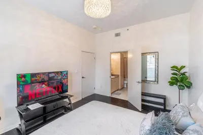a living room with a tv and a couch at 2 Bed Ocean View Balconys Corner Unit LB Convention Center in Long Beach