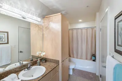 a bathroom with a sink and a toilet and a tub at 2 Bed Ocean View Balconys Corner Unit LB Convention Center in Long Beach