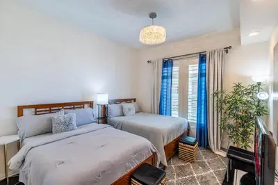 a bedroom with two beds and a window at 2 Bed Ocean View Balconys Corner Unit LB Convention Center in Long Beach