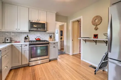 a kitchen with white cabinets and stainless steel appliances at Charming Santa Paula Home - Walk to Downtown! in Santa Paula