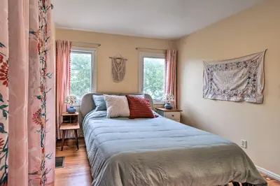 a bedroom with a bed and two windows at Charming Santa Paula Home - Walk to Downtown! in Santa Paula
