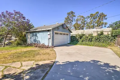a house with a garage with a driveway at Charming Santa Paula Home - Walk to Downtown! in Santa Paula
