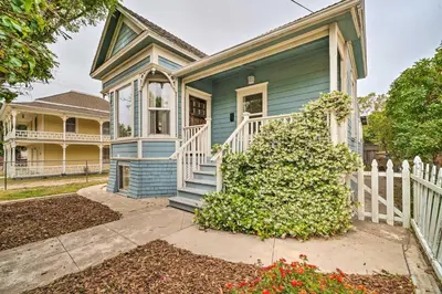a blue house with a white fence at Charming Santa Paula Home - Walk to Downtown! in Santa Paula
